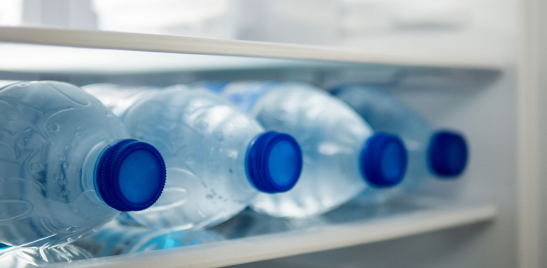 bottled water laying down in refrigerator